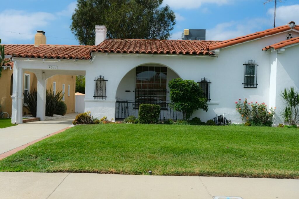 Classic white stucco Spanish-style home with red tile roof in California, representing inherited real estate and the step-up in basis